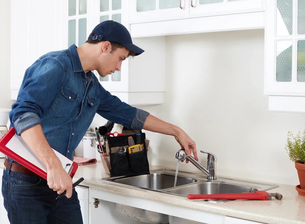 Professional plumber working on a sink